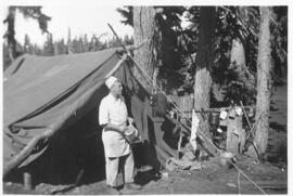 "The camp cook near tent, 1935"