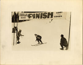 "Gertie skiing across finish line, 1940"