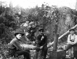 "Three Mountaineers around make-shift stove, 1907"
